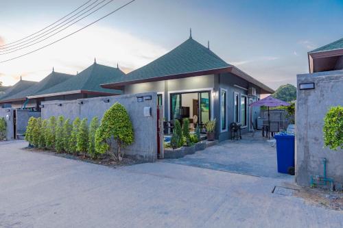 a house with a fence in front of it at N&D Poolvilla in Ao Nang Beach