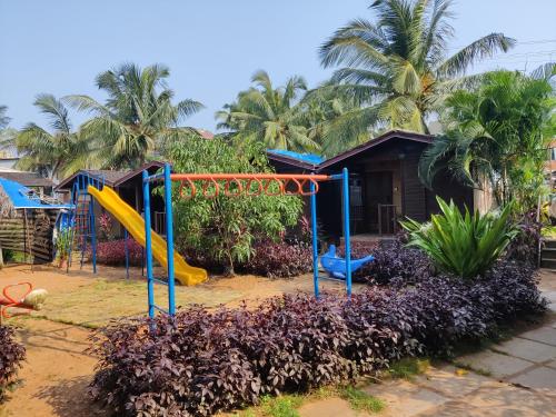a playground in front of a house at Pousada Donaciana - Beach Cottages in Baga