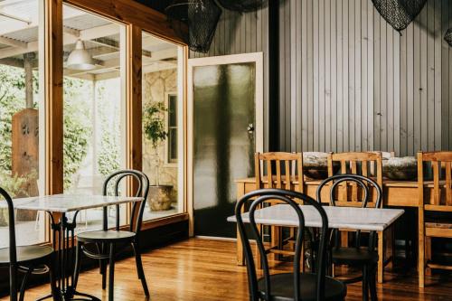 a restaurant with tables and chairs in a room at The Amalfi in Hepburn Springs