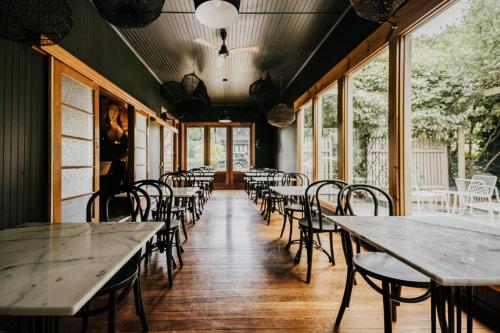 a row of tables and chairs in a restaurant at The Amalfi in Hepburn Springs