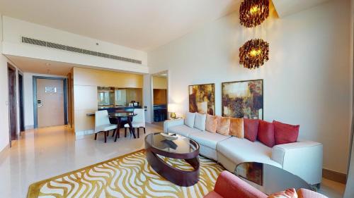 a living room with a couch and a table at Marriott Executive Apartments Dubai Al Jaddaf in Dubai