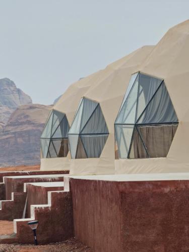 three glass domes on a building in the desert at Ammar Rum Camp and jeep tour in Wadi Rum