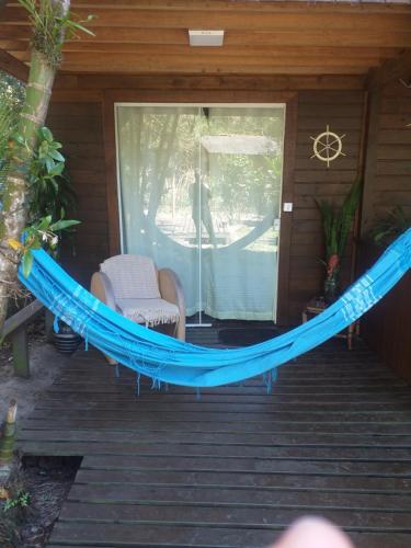 a hammock on a porch of a house at Suíte Solar in Ilha do Mel