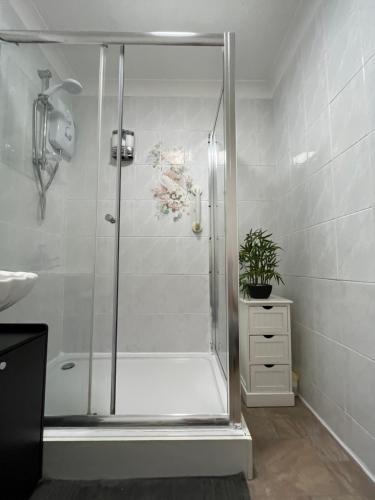 a shower with a glass door in a bathroom at Park Cottage in Scunthorpe