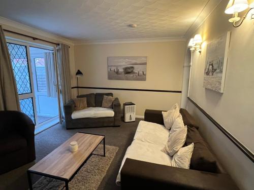 a living room with a couch and a coffee table at Park Cottage in Scunthorpe