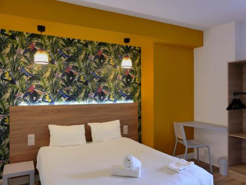 a bedroom with a bed and a wall with a mural at KYRIAD DIRECT TOULON OUEST - La Seyne sur Mer in La Seyne-sur-Mer