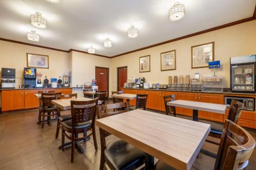 a restaurant with tables and chairs and a counter at Best Western Los Angeles Worldport Hotel in Wilmington
