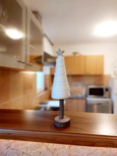 a statue of a dress on a table in a kitchen at Lexi Jakuzzis Apartman Balatonboglár in Balatonboglár