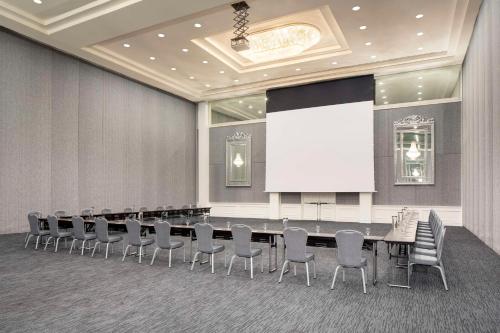 een vergaderzaal met een tafel en stoelen en een scherm bij Hyatt Regency Grand Reserve Puerto Rico in Rio Grande