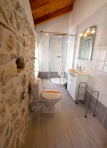 a bathroom with a toilet and a sink and a shower at Guesthouse Merla in Šibenik