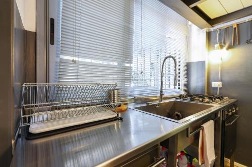 une cuisine avec un évier et un comptoir en acier inoxydable dans l'établissement PrimoPiano - Padova 5, à Milan