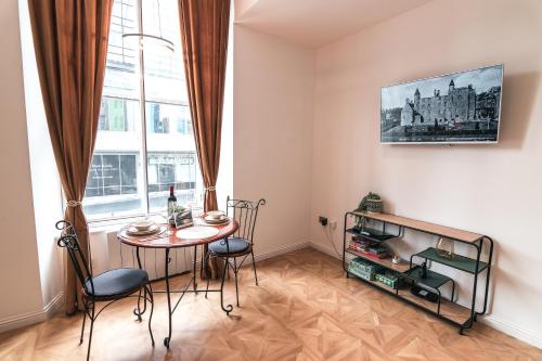 a living room with a table and a tv at Modern apartment in Aberdeen City Centre, Guild street, free WiFi in Aberdeen