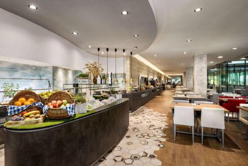 a restaurant with a counter with fruits and vegetables on it at Vienna House by Wyndham Andel's Prague in Prague