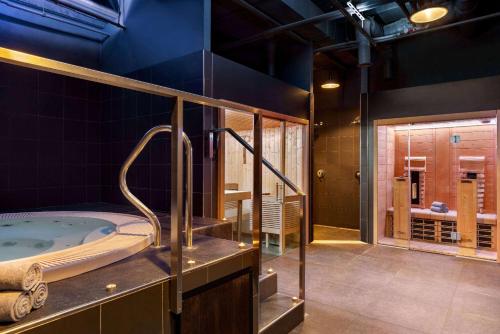 a bathroom with a jacuzzi tub in a room at Vienna House by Wyndham Andel's Prague in Prague