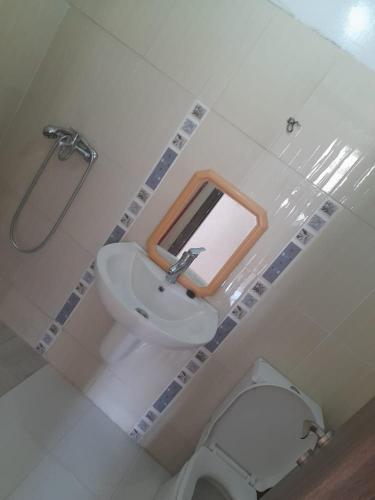 a bathroom with a sink and a toilet and a mirror at تطوان in Tétouan