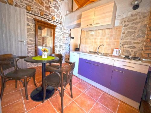 a kitchen with a table and chairs and a sink at Guesthouse Merla in Šibenik