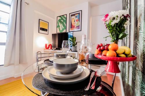 a dining room table with a bowl of fruit on it at Steps to Oxford Street-Central 1BR Flat Sleeps 4 in London