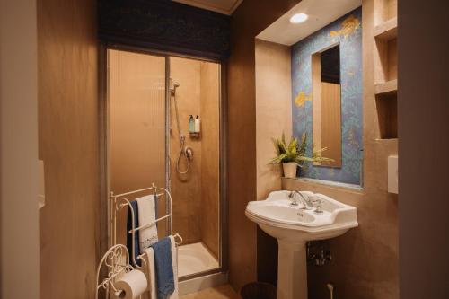 a bathroom with a sink and a shower at Hotel Oviv dimora del borgo in Acquaviva Picena