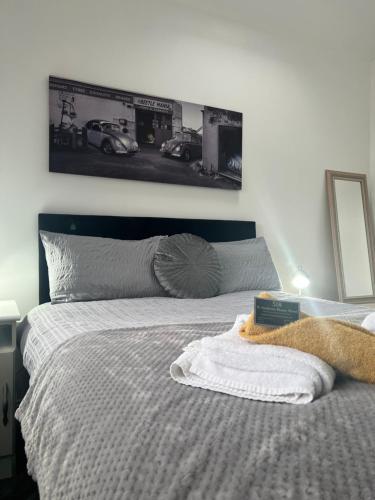 a bedroom with a bed with a picture on the wall at The Annexe, St Andrews house hotel, Two bedrooms Sleeps 4 in Preston