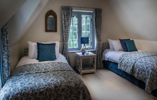 Postelja oz. postelje v sobi nastanitve Stone Lodge at Combermere Abbey