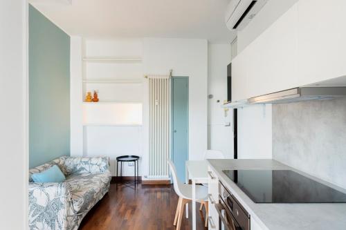 a kitchen and a living room with a couch at RELSTAY - Washington Street in Milan