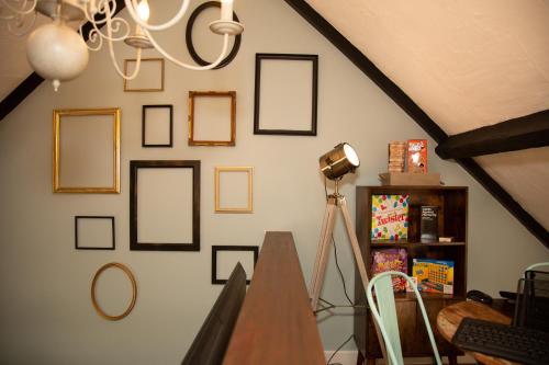 a room with framed pictures on a wall at Quirky Boutique 1840s Stable in Torquay