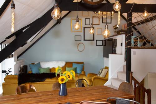 a dining room with a table and a couch at Quirky Boutique 1840s Stable in Torquay