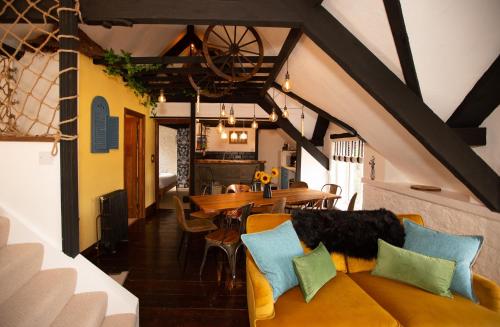 a living room with a couch and a table at Quirky Boutique 1840s Stable in Torquay