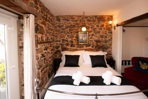 a bedroom with a bed with two teddy bears on it at Quirky Boutique 1840s Stable in Torquay