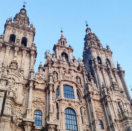 a large building with two towers on top of it at Apartamento SIRO Compostela in Santiago de Compostela