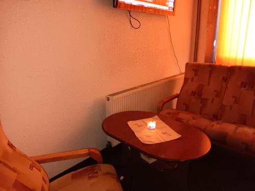 a small table and a chair in a room at Ubytovna u hospůdky in Ostrava