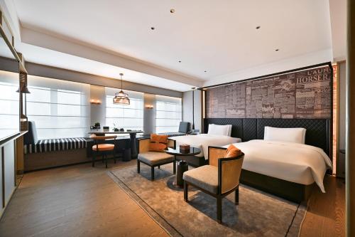 廣州的住宿－Arthur Hotel Luogang Guangzhou，配有一张床和一张书桌的酒店客房