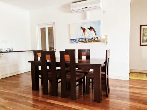 a dining room with a table and chairs at Colombo City 3 Bedroom Apartment with Pool Gym & Workdesk in Colombo