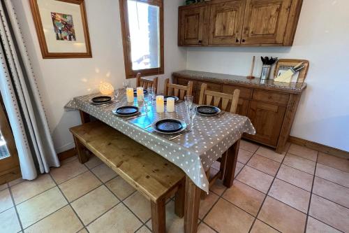 a table in a kitchen with a table cloth on it at Les Granges 13 6-8 person in Aime-La Plagne