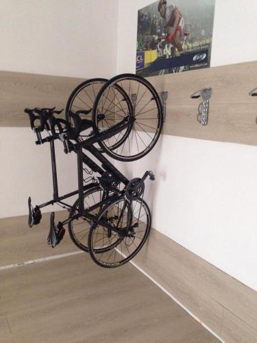 a bike is hanging on a wall at Hotel Gracia in El Arenal