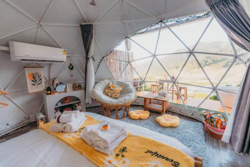 a large room with a bed in a tent at Paopao Orange Farm and Home stay in Mae Rim