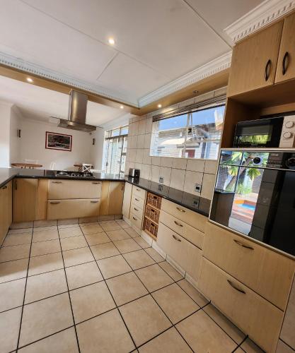 a large kitchen with a large tiled floor at FM GUEST LODGE Comfort, Tranquility & Peace of Mind in Johannesburg