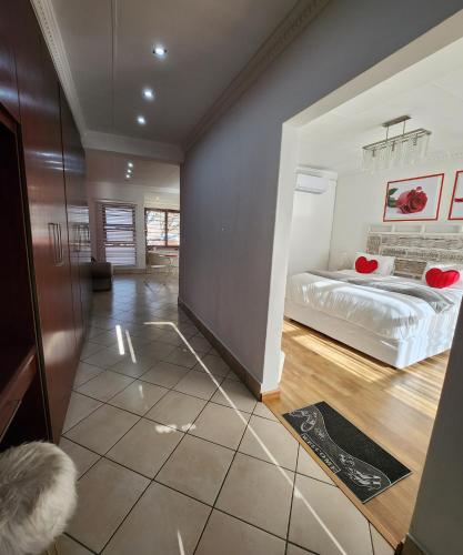 a bedroom with a bed in a room at FM GUEST LODGE Comfort, Tranquility & Peace of Mind in Johannesburg