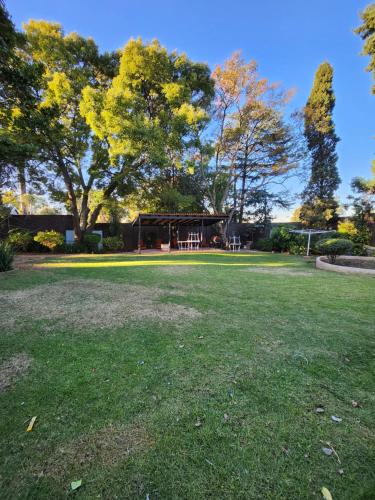 a park with a pavilion in the middle of a field at FM GUEST LODGE Comfort, Tranquility & Peace of Mind in Johannesburg