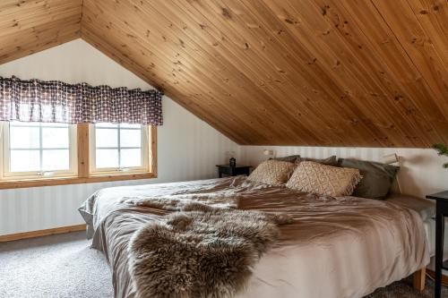 a bedroom with a large bed with a wooden ceiling at Idre Himmelfjäll, Vintergatan 2 in Idre