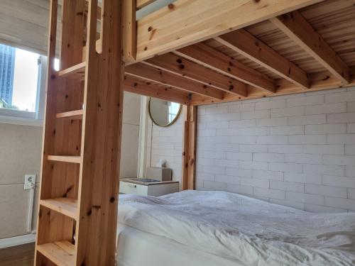 a loft bed with a ladder in a bedroom at Sokcho Hutte in Sokcho