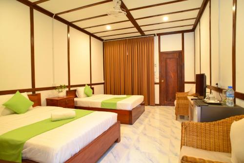 Кровать или кровати в номере Densy Angkor Bungalow