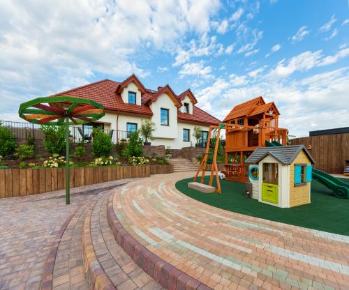 a house with a playground with a play equipment at Lisie Sprawki in Bebło