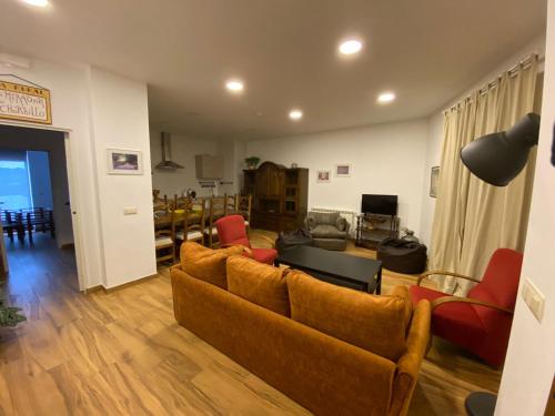a living room with two couches and a table at El Mirador del Chorrillo in Olmeda de las Fuentes