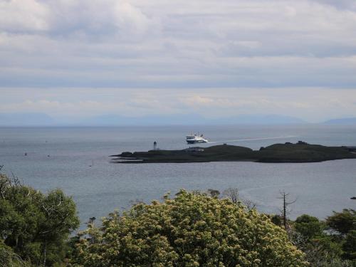 a boat on an island in the water at Dunard Villa in Stornoway