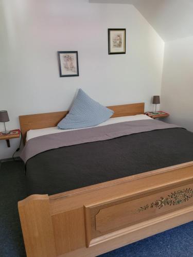 a bedroom with a large bed with a wooden frame at Ferienhaus Gertrud in Nesselwängle