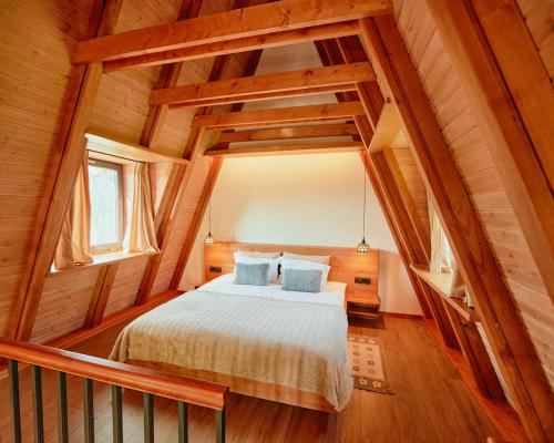 a bedroom with a bed in a wooden house at Aruna Bran in Bran