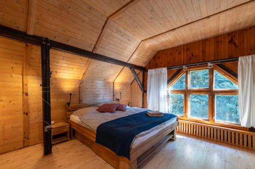 um quarto com uma cama num chalé de madeira em Dom na Szczycie Góry Równica em Ustroń