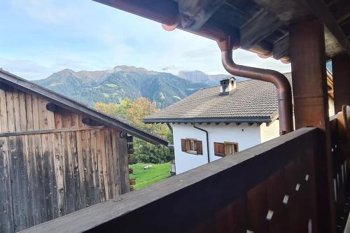 a view from a balcony of a building with mountains in the background at Casa Biala Dimora - Ski IN/OUT in Vigens