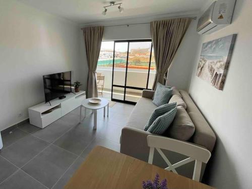 a living room with a couch and a table at Elm Apartament in Sagres